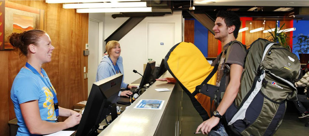 Backpacker checking into a Gold Coast hostel reception